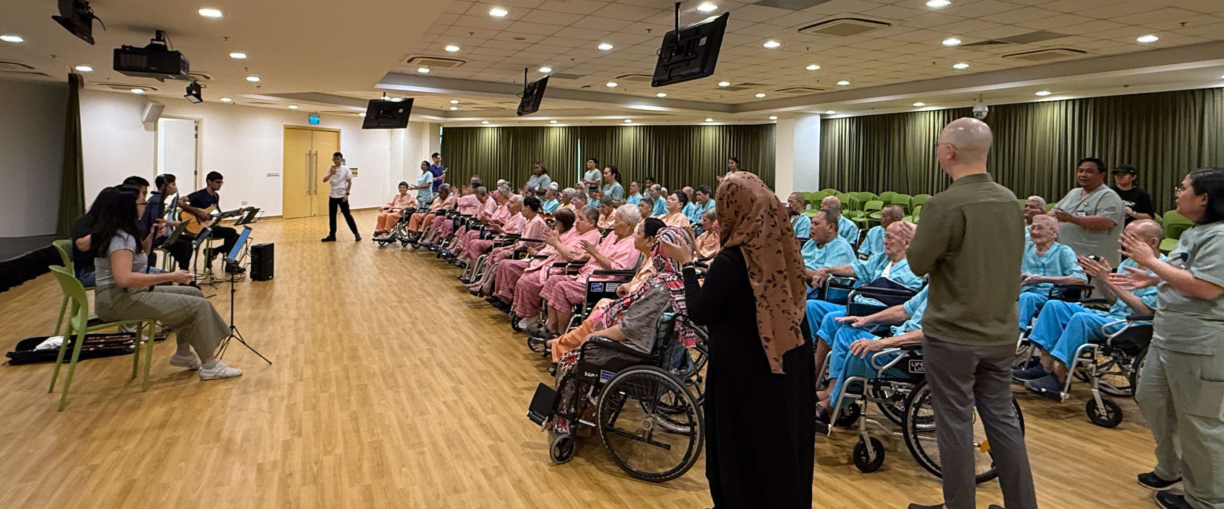 Seniors enjoying performances from Teng Gives Back musicians.